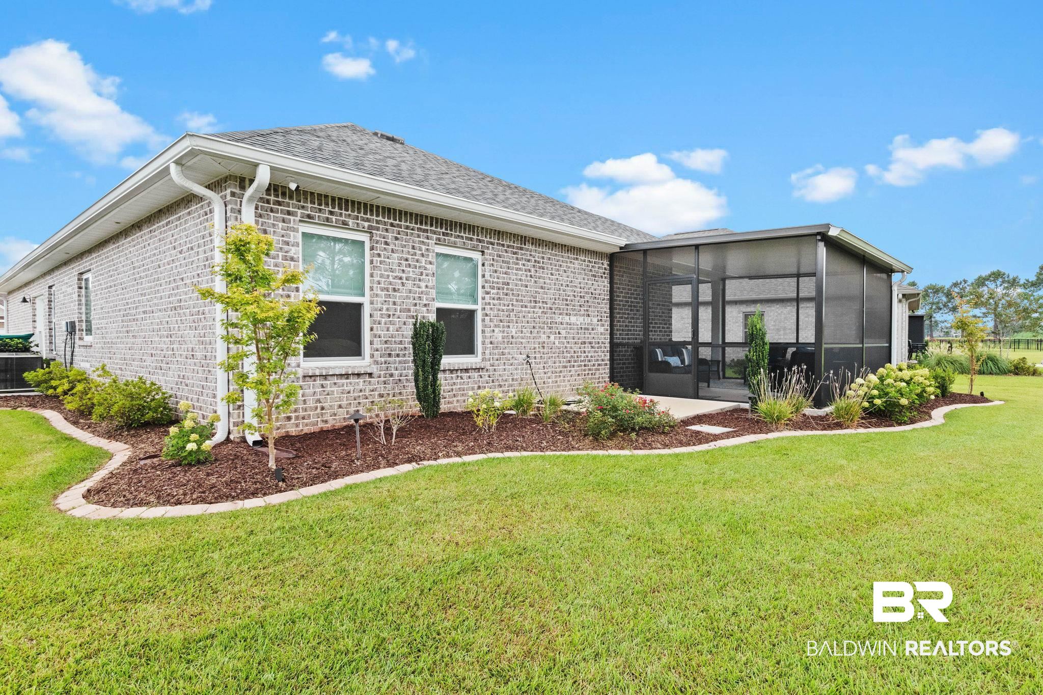 9815 Lakeview Drive Foley, AL 36535 - Photo 74 of 100 Back of house featuring a sunroom and a yard