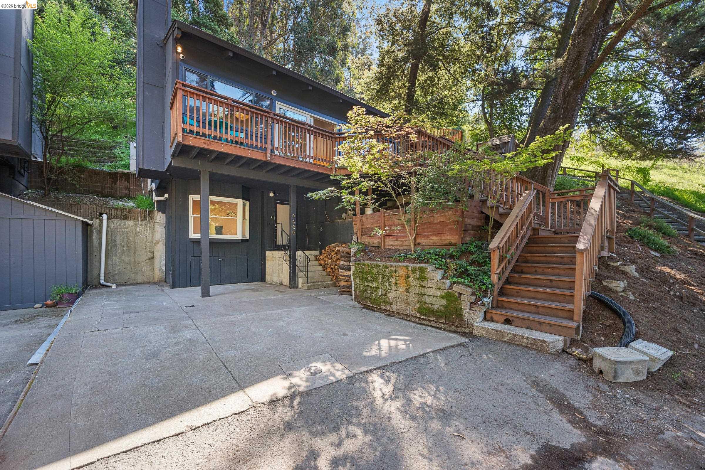 Back of property with a deck and stairs