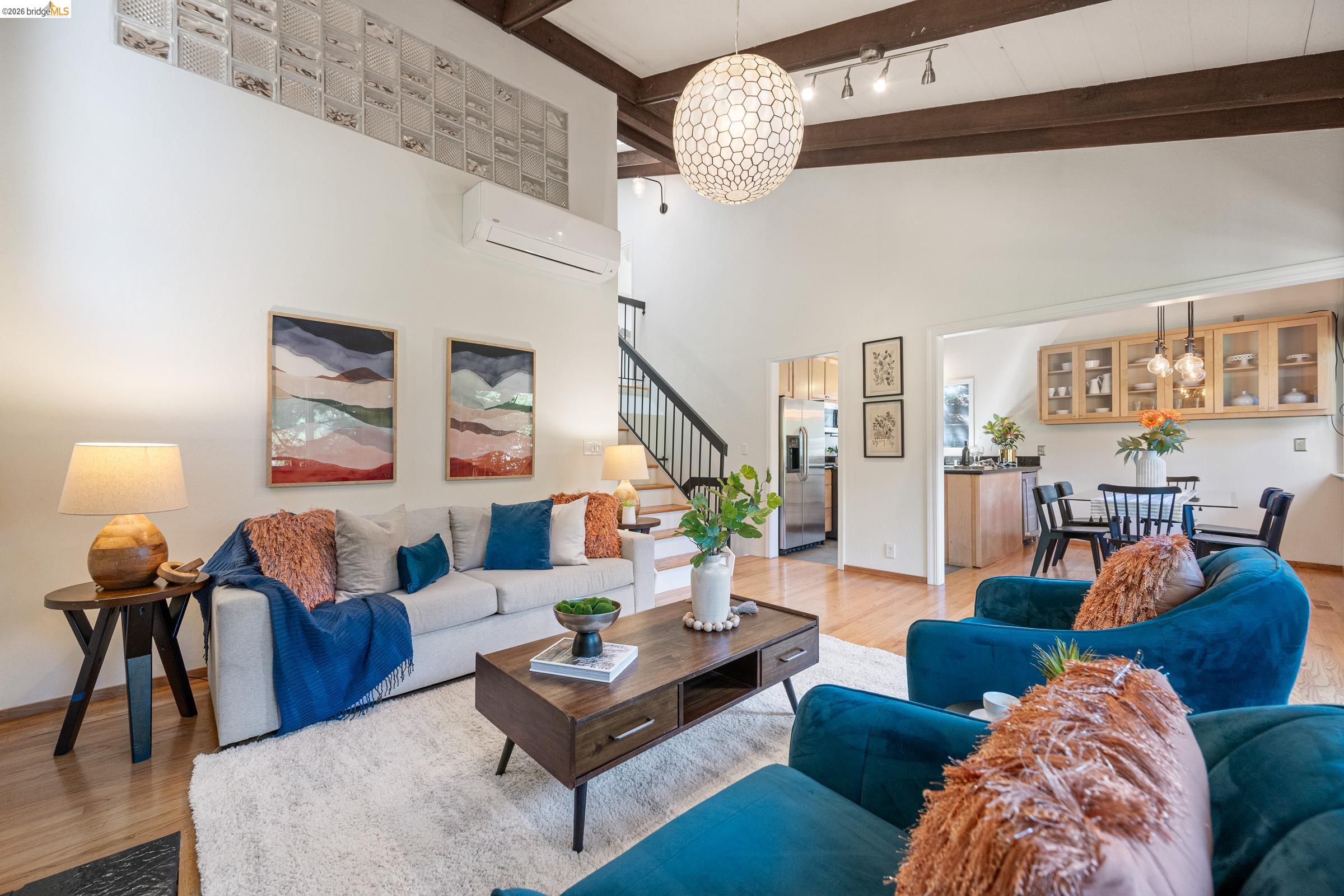 6600 Heather Ridge Way Oakland, CA 94611 - Photo 11 of 58 Living room with suspended lighting and light wood-type flooring