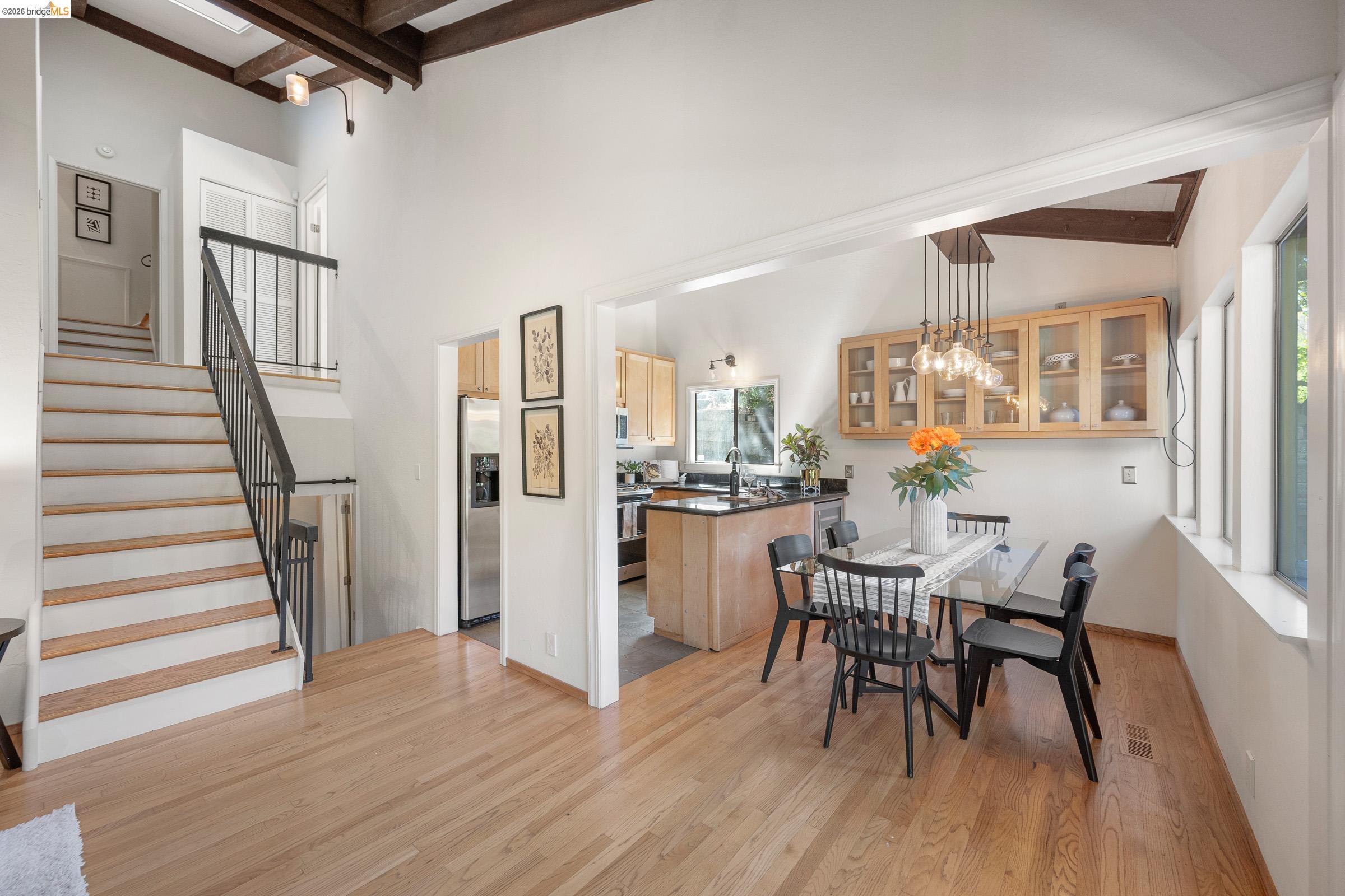 6600 Heather Ridge Way Oakland, CA 94611 - Photo 18 of 58 Dining area featuring light wood-type flooring, hanging lights, and lofted ceiling