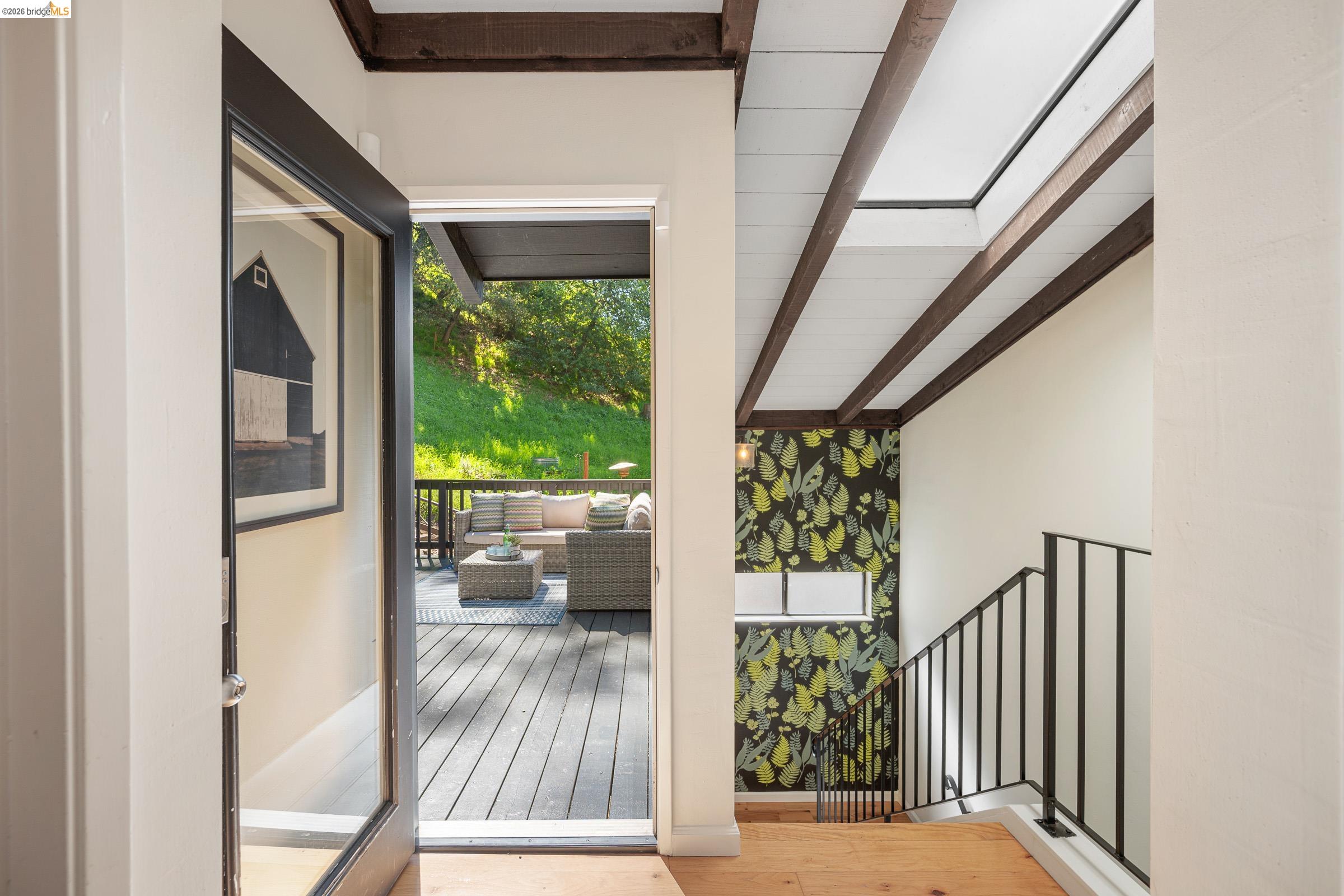 6600 Heather Ridge Way Oakland, CA 94611 - Photo 46 of 58 Doorway with beam ceiling and wood finished floors