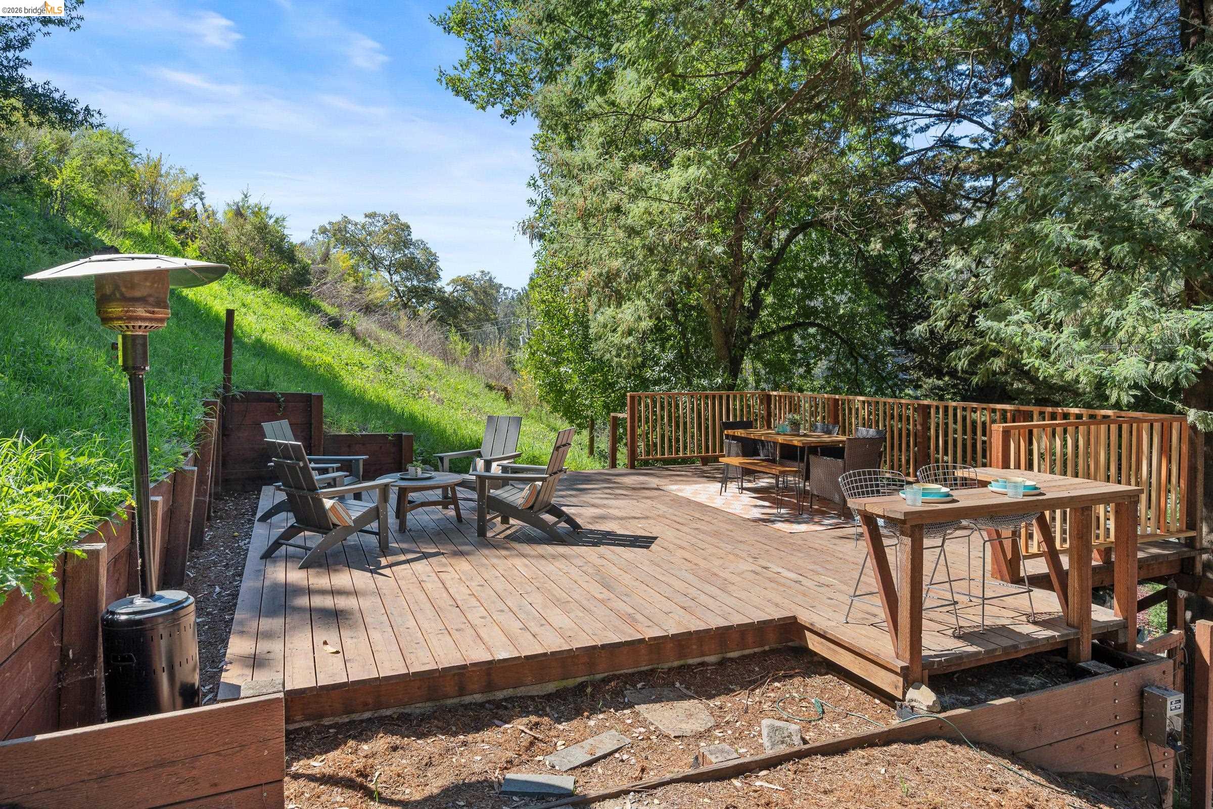 6600 Heather Ridge Way Oakland, CA 94611 - Photo 48 of 58 Wooden terrace featuring outdoor dining space and a fire pit