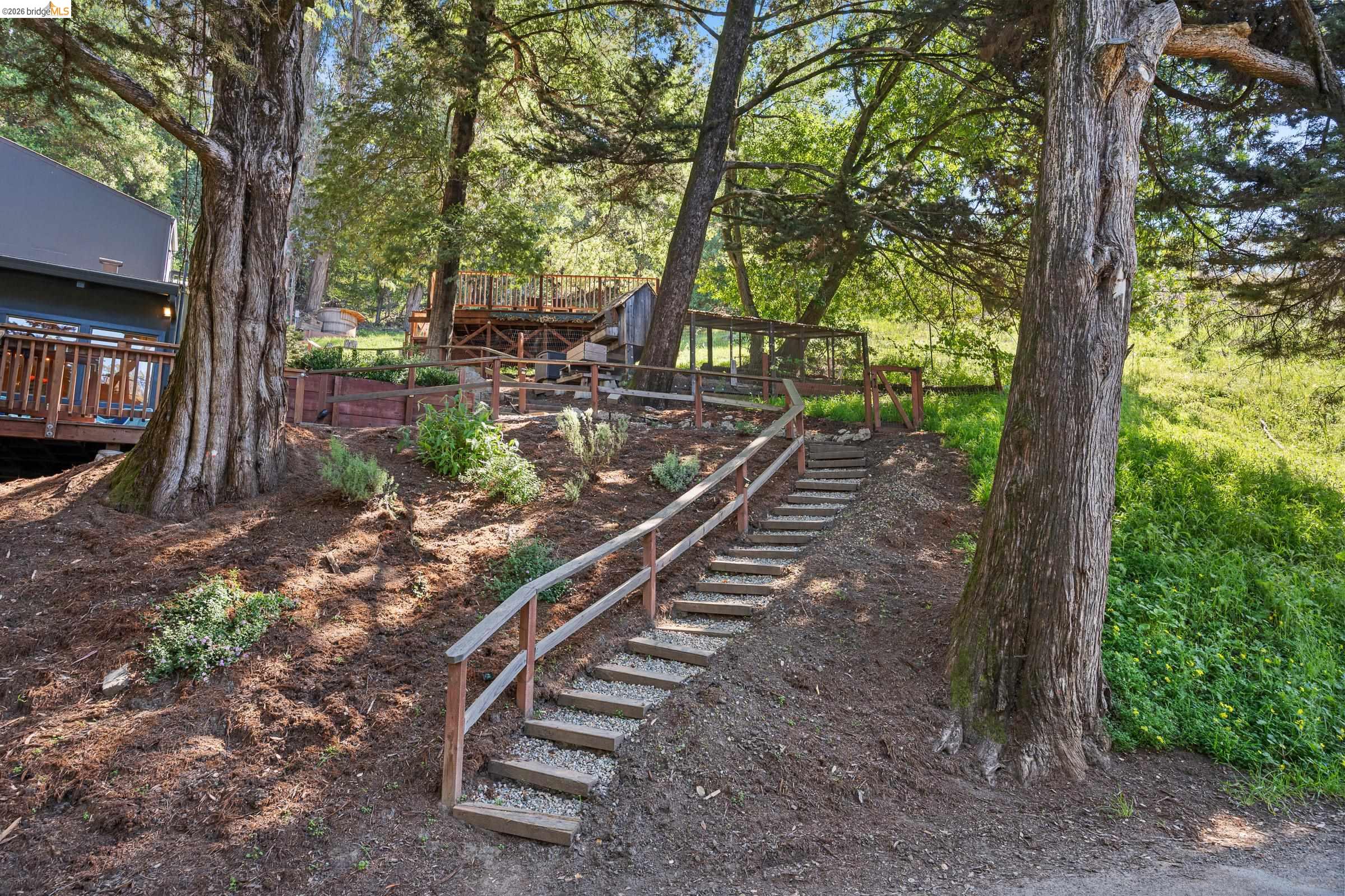 6600 Heather Ridge Way Oakland, CA 94611 - Photo 54 of 58 View of yard featuring stairway and a wooden deck