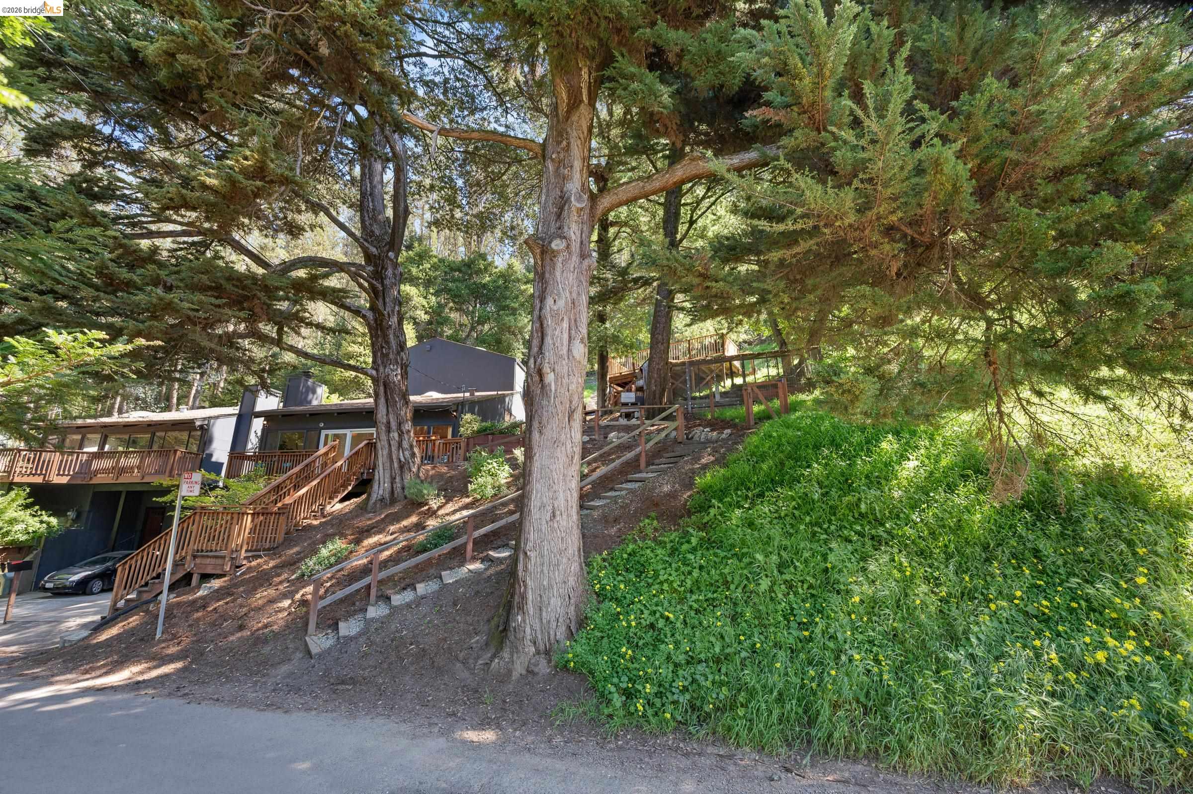 6600 Heather Ridge Way Oakland, CA 94611 - Photo 58 of 58 View of yard with a deck and view of wooded area