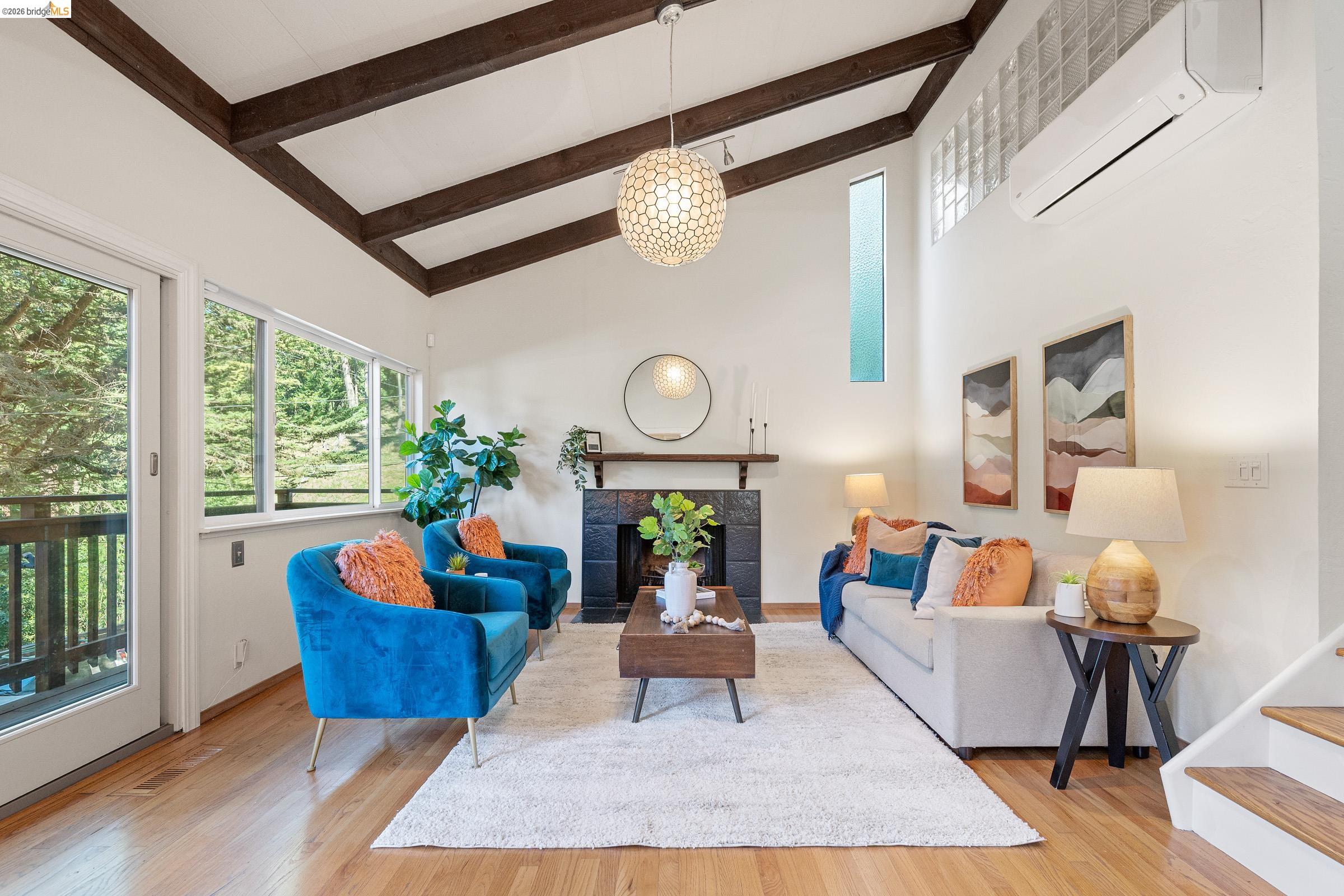 6600 Heather Ridge Way Oakland, CA 94611 - Photo 6 of 58 Living room featuring a fireplace, light wood-type flooring, and lofted ceiling