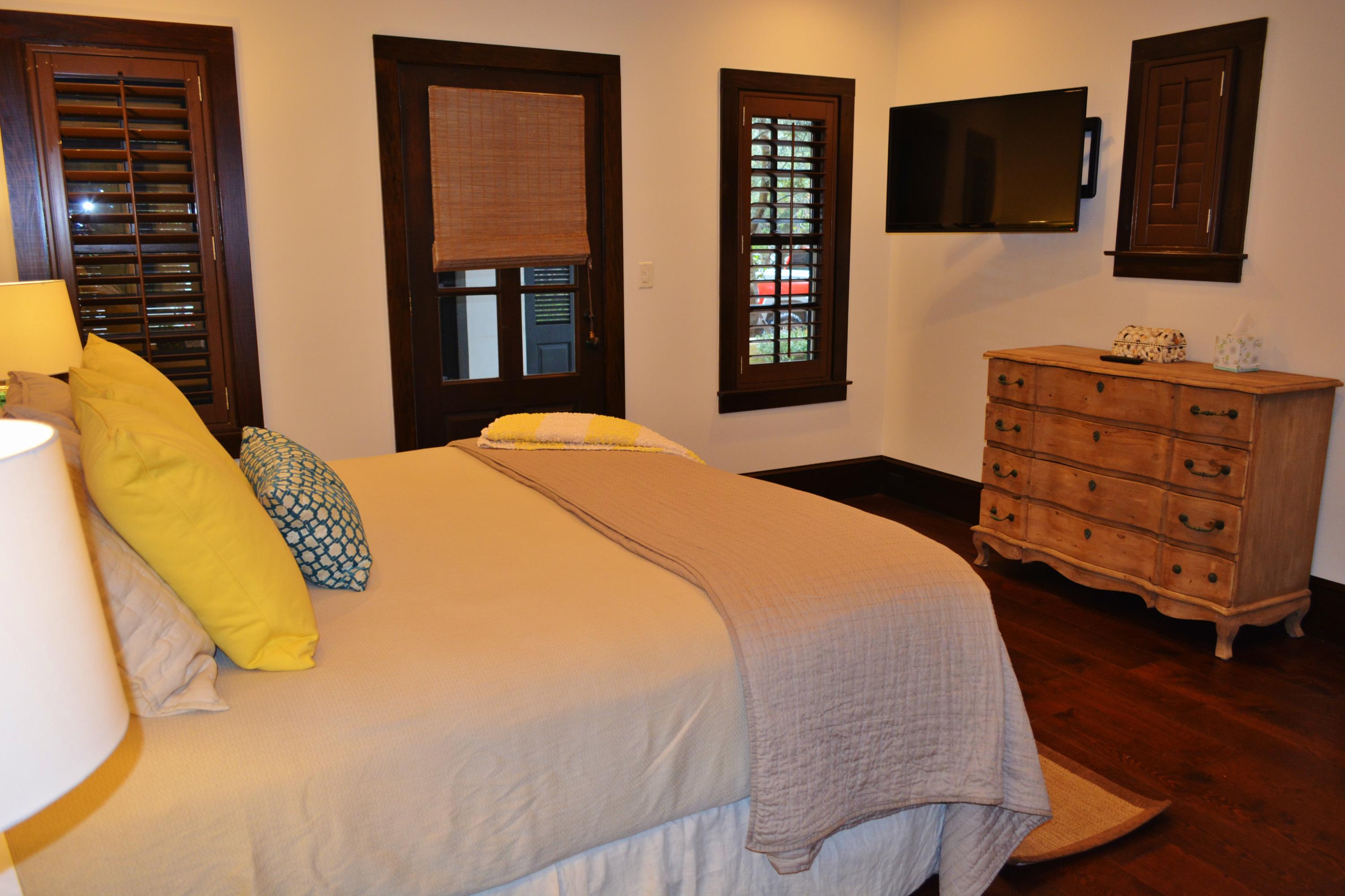 102 Round Road Rosemary Beach, FL 32461 - Photo 14 of 36 a bedroom with a bed and wooden floor