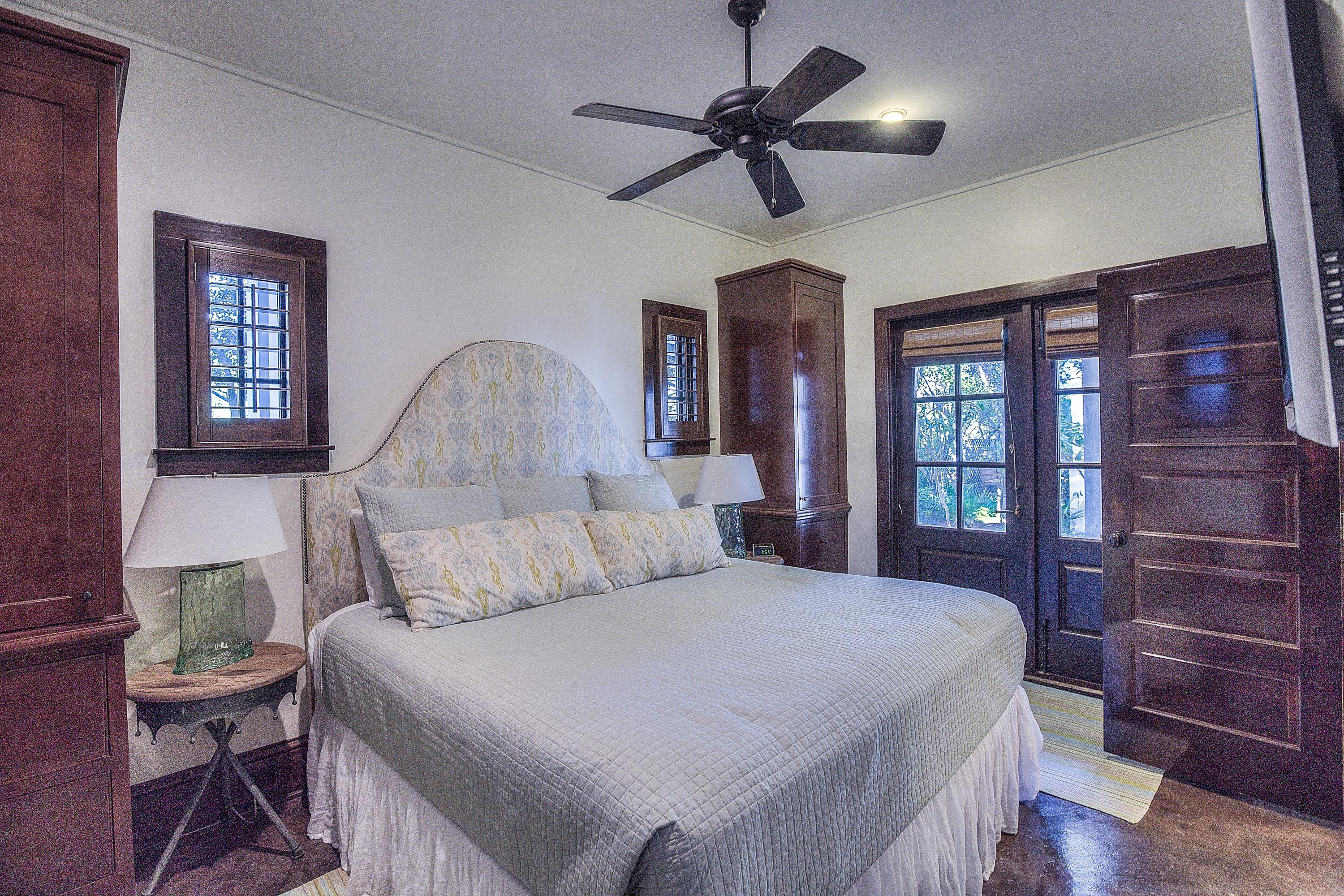 102 Round Road Rosemary Beach, FL 32461 - Photo 17 of 36 a bedroom with a large bed and a chandelier
