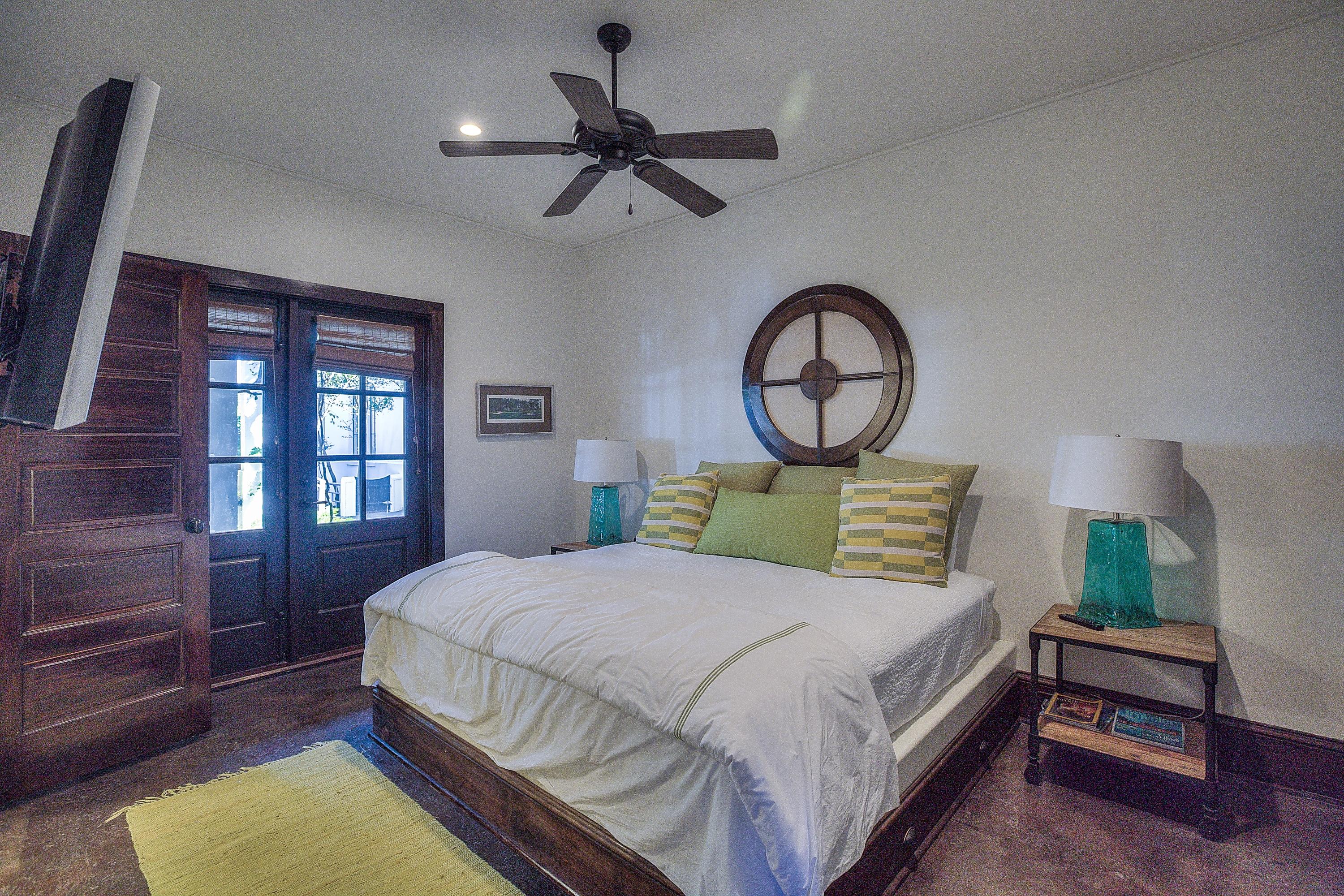 102 Round Road Rosemary Beach, FL 32461 - Photo 18 of 36 a bedroom with a bed a dresser and windows