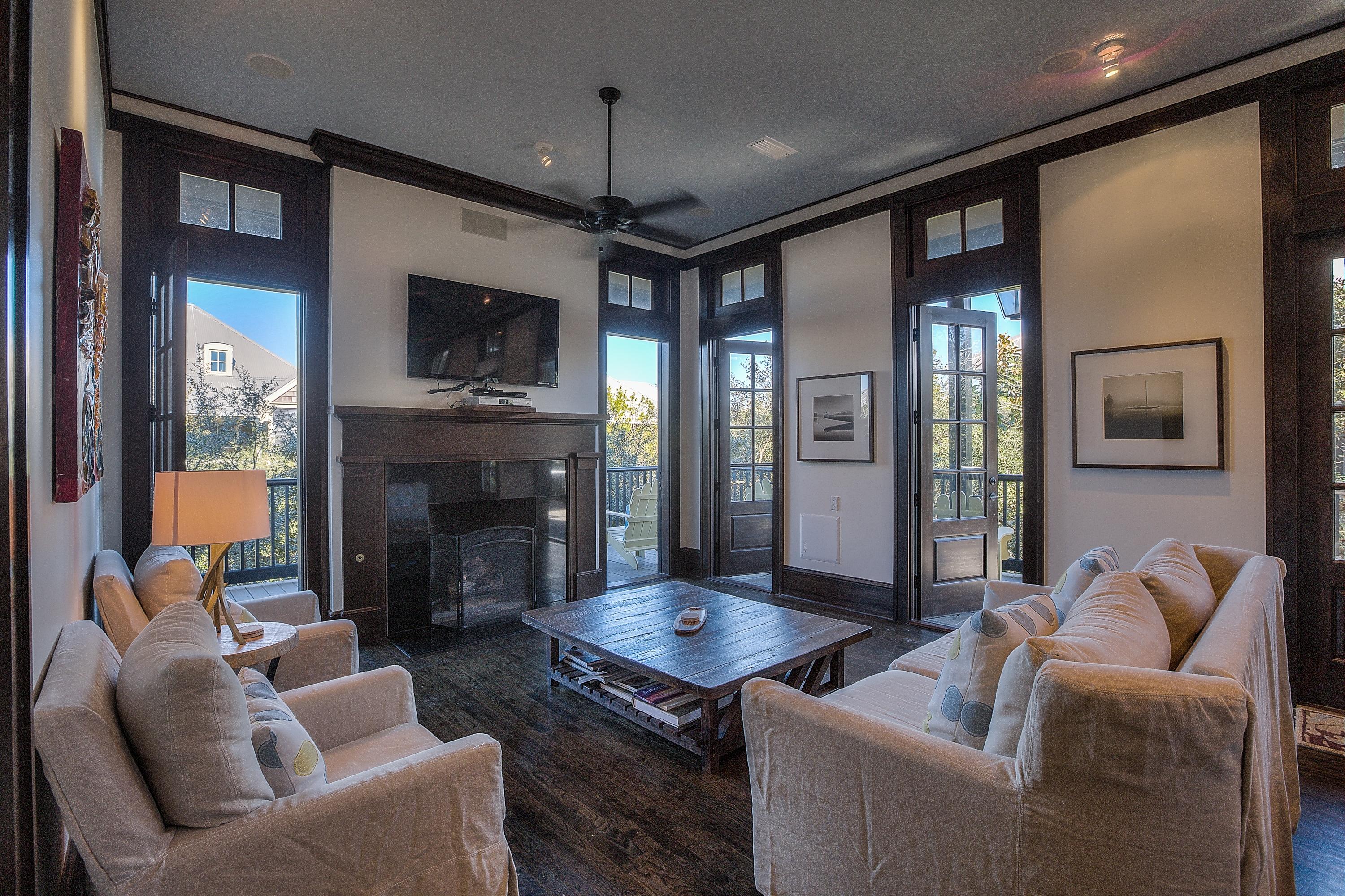 102 Round Road Rosemary Beach, FL 32461 - Photo 4 of 36 a living room with furniture a flat screen tv and a fireplace