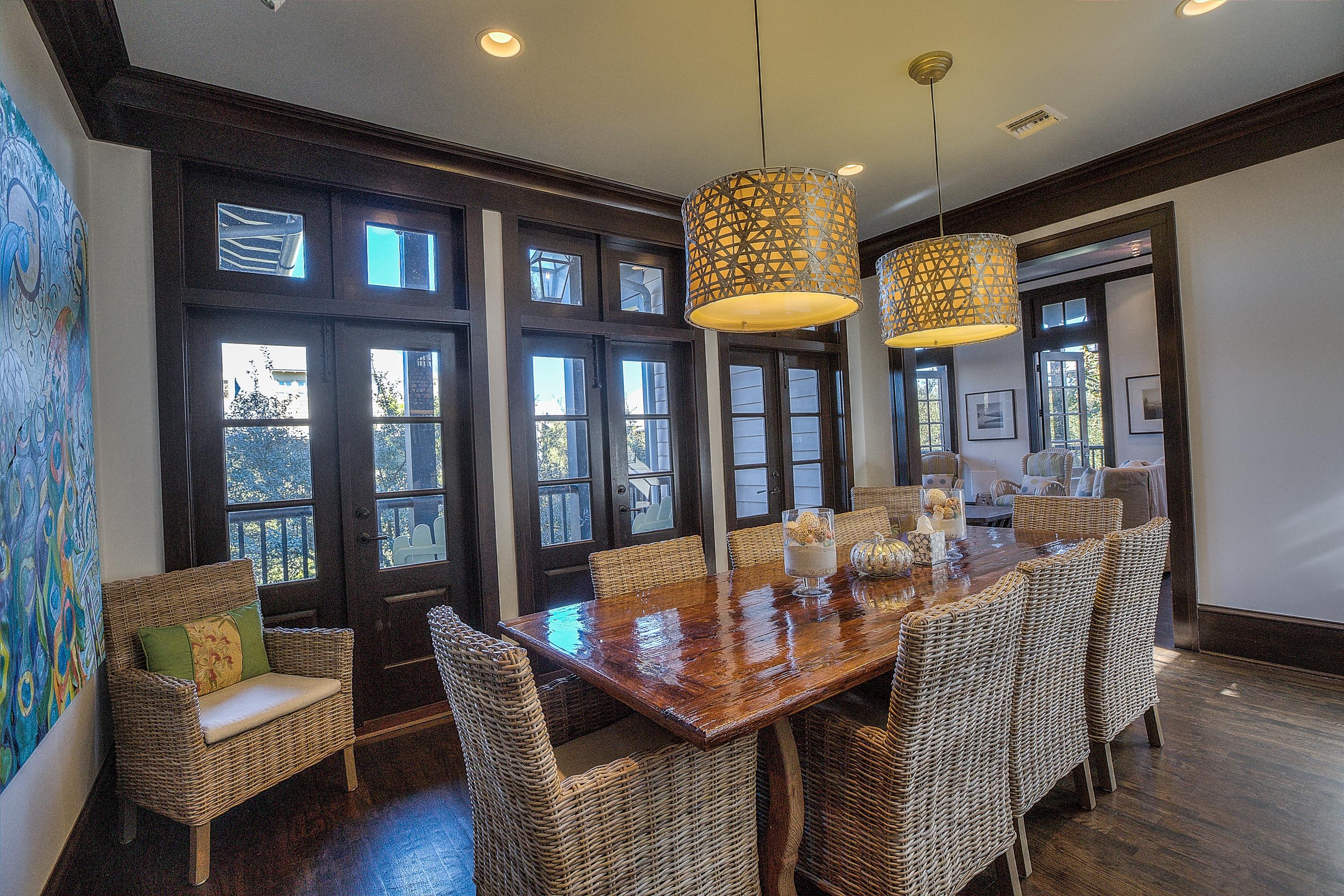 102 Round Road Rosemary Beach, FL 32461 - Photo 6 of 36 a view of a dining room with furniture a chandelier and wooden floor
