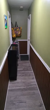 a view of a hallway with wooden floor