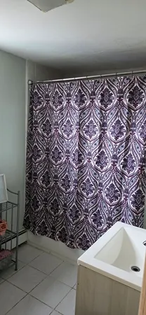 a kitchen with stainless steel appliances granite countertop a stove top oven a dining table and chairs with wooden floor