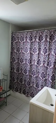 a kitchen with stainless steel appliances granite countertop a stove top oven a dining table and chairs with wooden floor