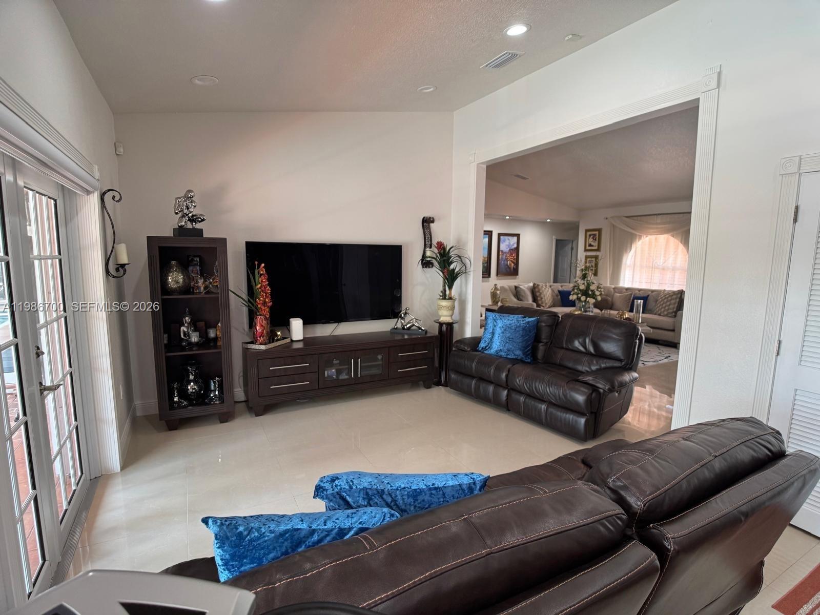 14620 Southwest 151st Terrace Miami, FL 33196 - Photo 11 of 30 a living room with furniture and a flat screen tv