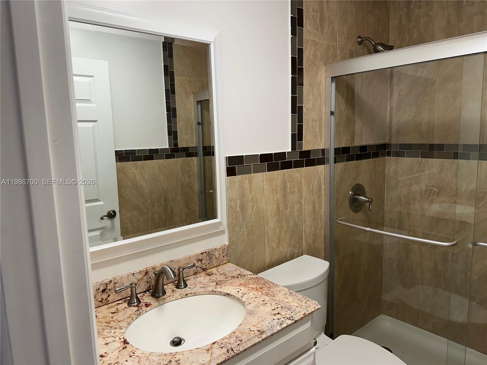 14620 Southwest 151st Terrace Miami, FL 33196 - Photo 14 of 30 a bathroom with a granite countertop sink toilet and shower