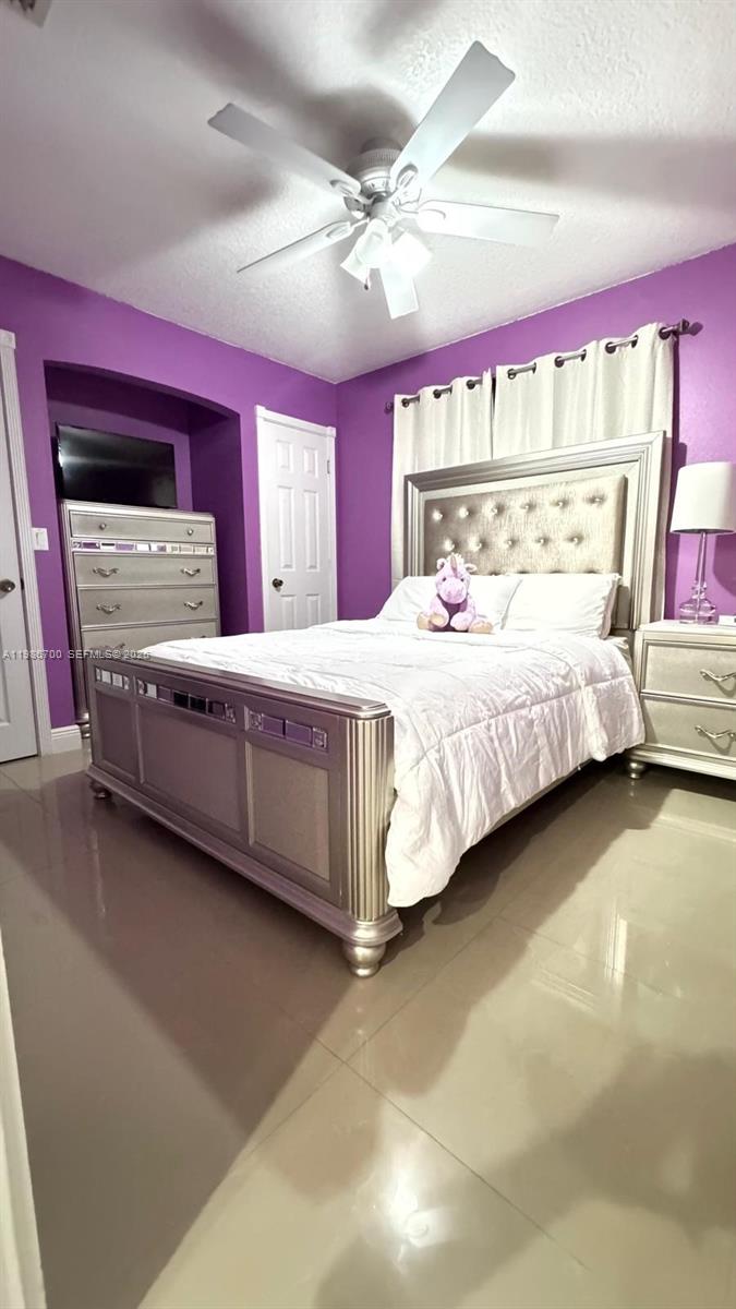 14620 Southwest 151st Terrace Miami, FL 33196 - Photo 16 of 30 a bedroom with a bed and window