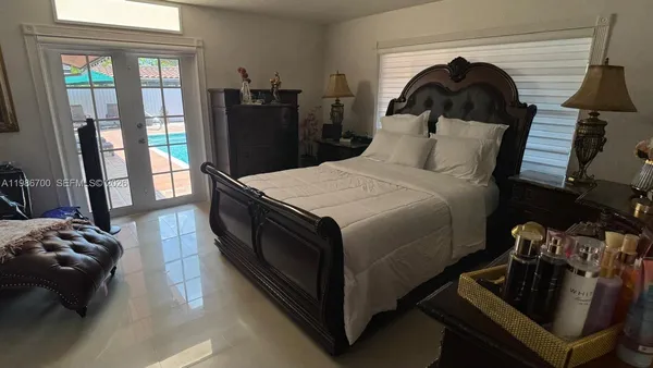 a bedroom with a bed couch and a window