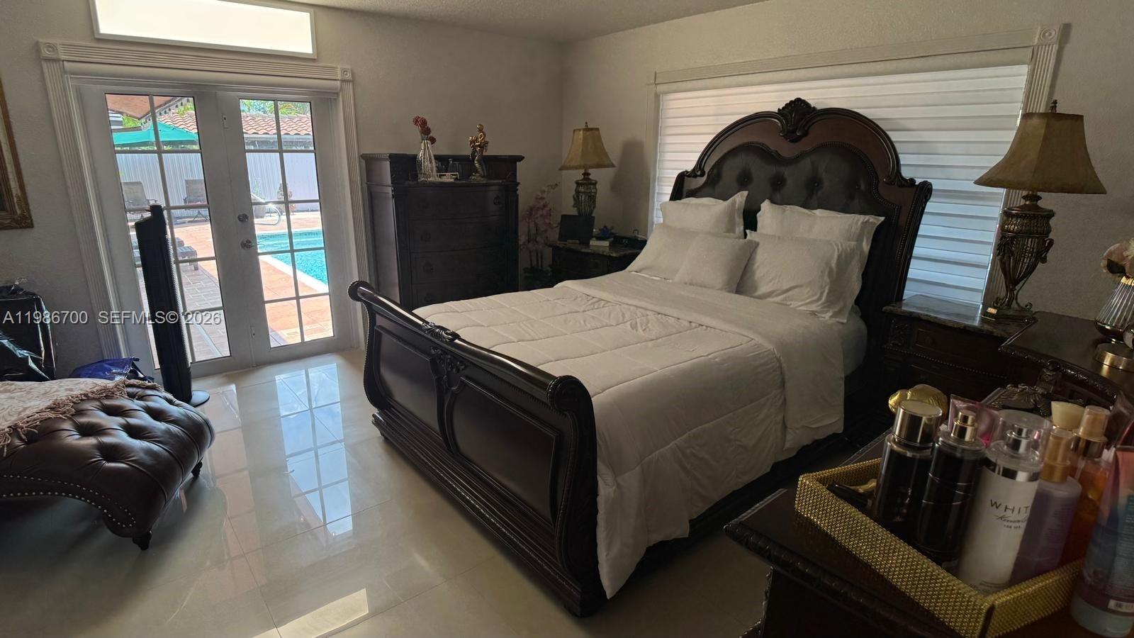 14620 Southwest 151st Terrace Miami, FL 33196 - Photo 19 of 30 a bedroom with bed and glass door