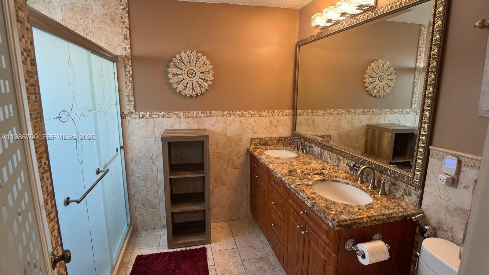 14620 Southwest 151st Terrace Miami, FL 33196 - Photo 20 of 30 a bathroom with a sink a vanity and a mirror