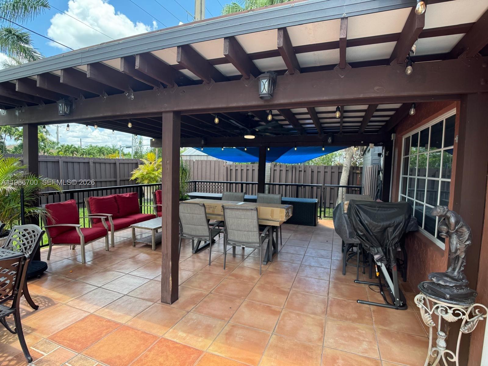 14620 Southwest 151st Terrace Miami, FL 33196 - Photo 24 of 30 a view of a chairs and table in a patio