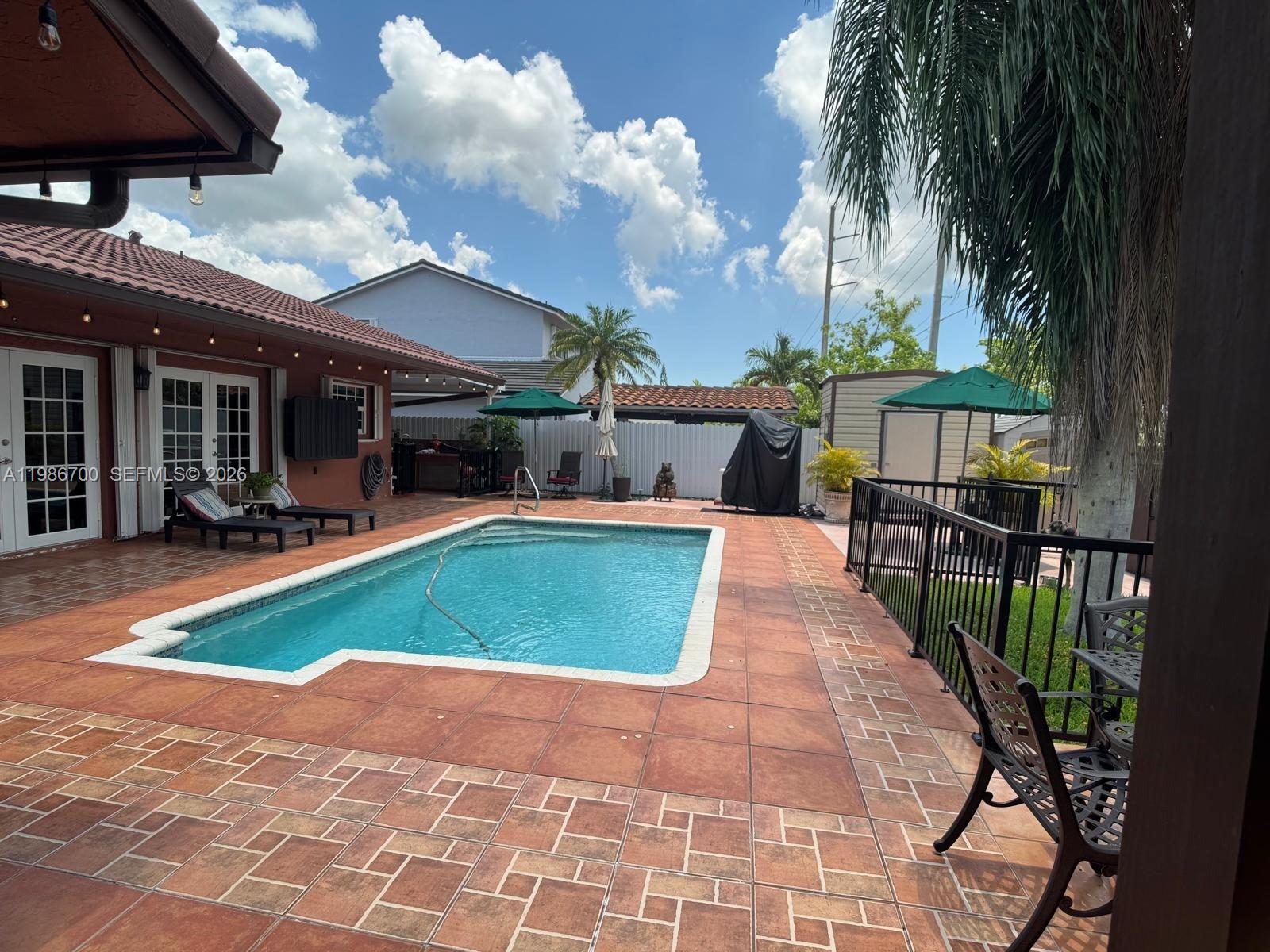 14620 Southwest 151st Terrace Miami, FL 33196 - Photo 25 of 30 a view of a swimming pool with a patio
