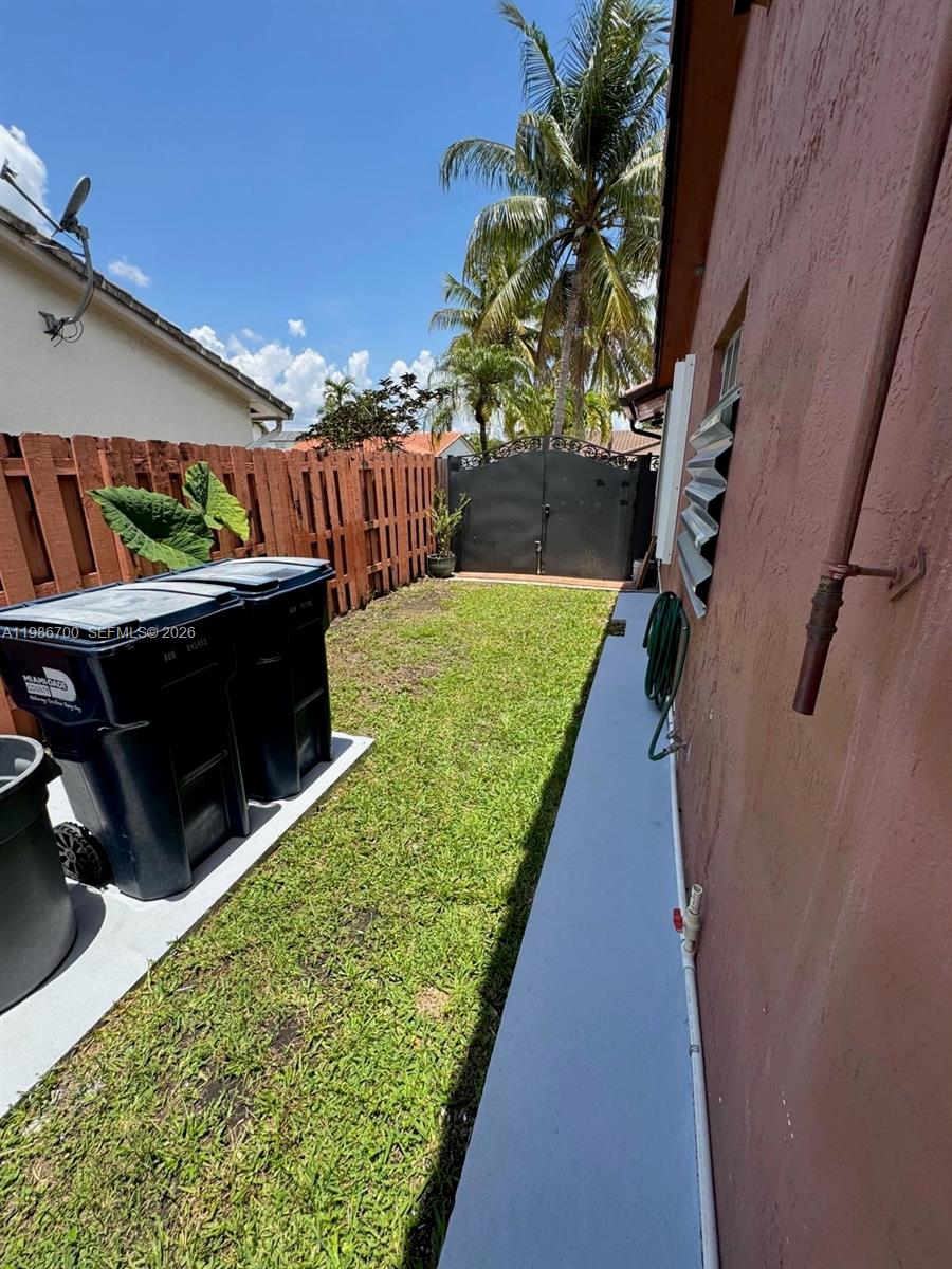 14620 Southwest 151st Terrace Miami, FL 33196 - Photo 27 of 30 a view of a backyard with wooden fence