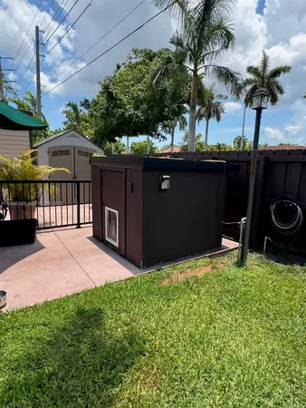 a couple of potted plants in front of door with wooden fence