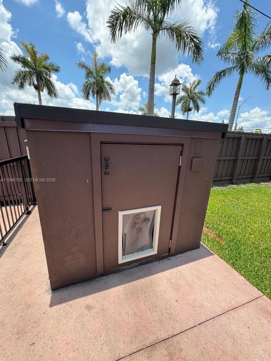 14620 Southwest 151st Terrace Miami, FL 33196 - Photo 30 of 30 a couple of potted plants in front of door with wooden fence
