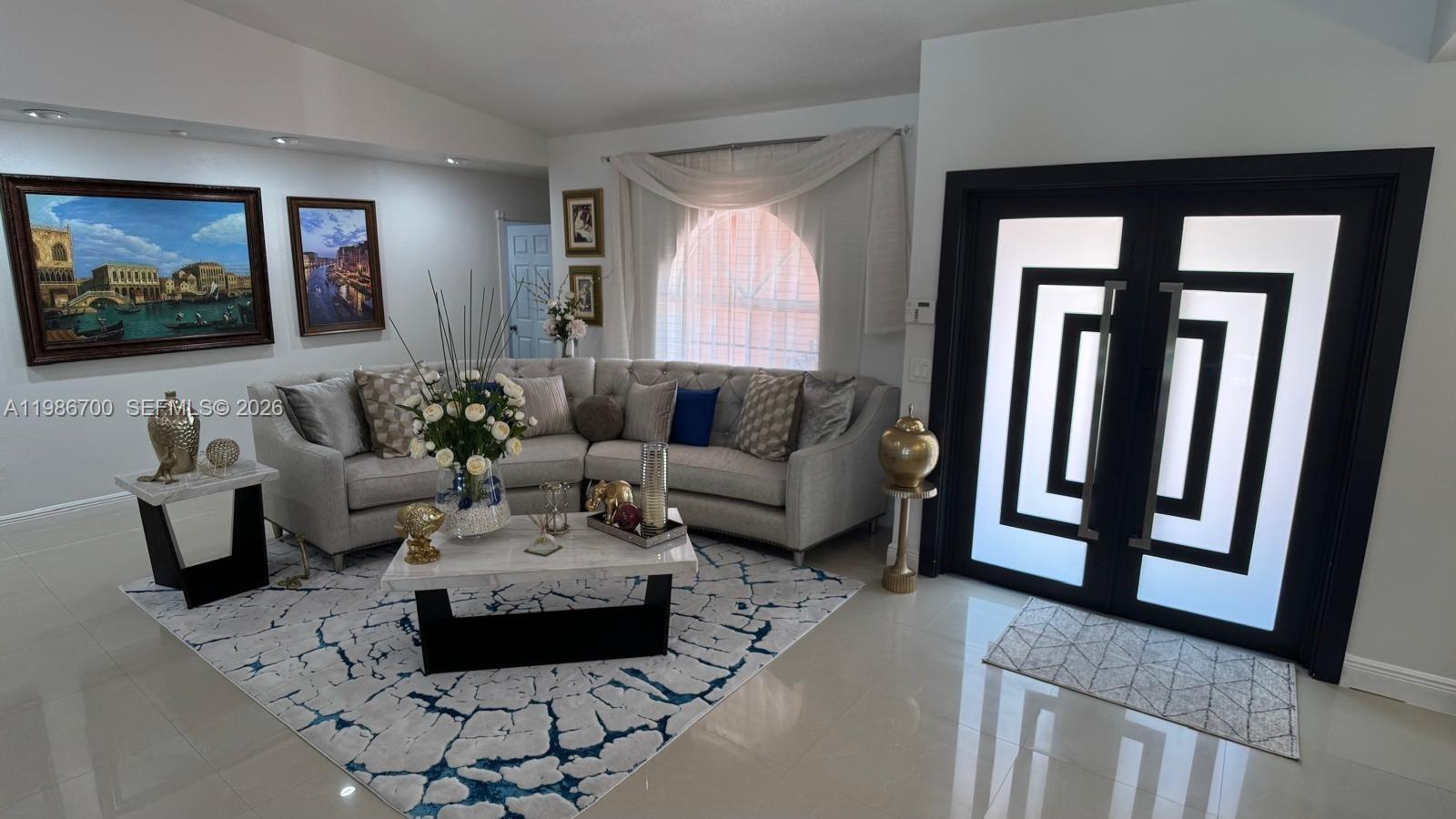 14620 Southwest 151st Terrace Miami, FL 33196 - Photo 3 of 30 a living room with furniture and a flat screen tv