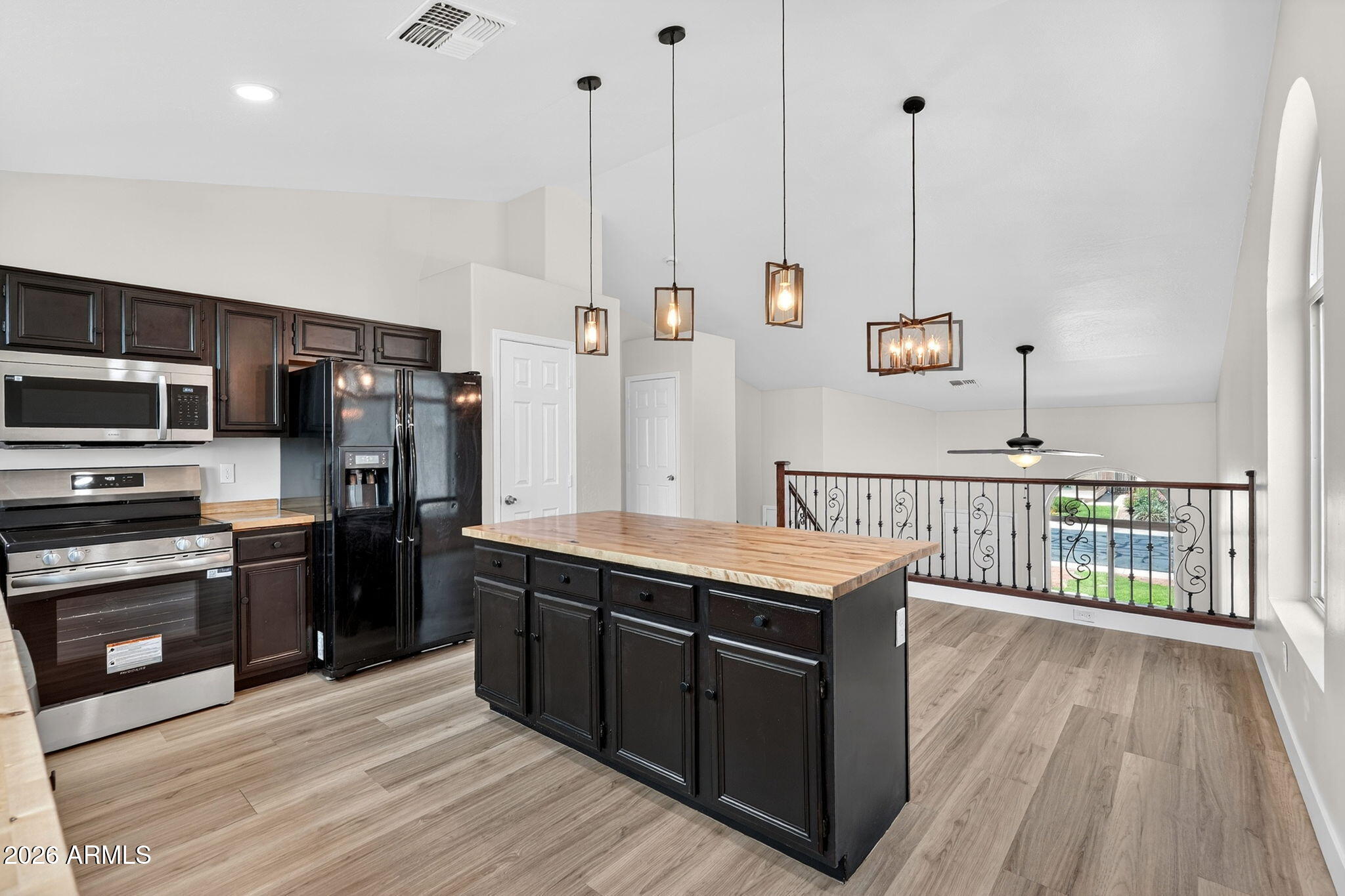 1417 East Mineral Road Gilbert, AZ 85234 - Photo 21 of 59 a kitchen with stainless steel appliances kitchen island granite countertop a stove a sink and a wooden floors