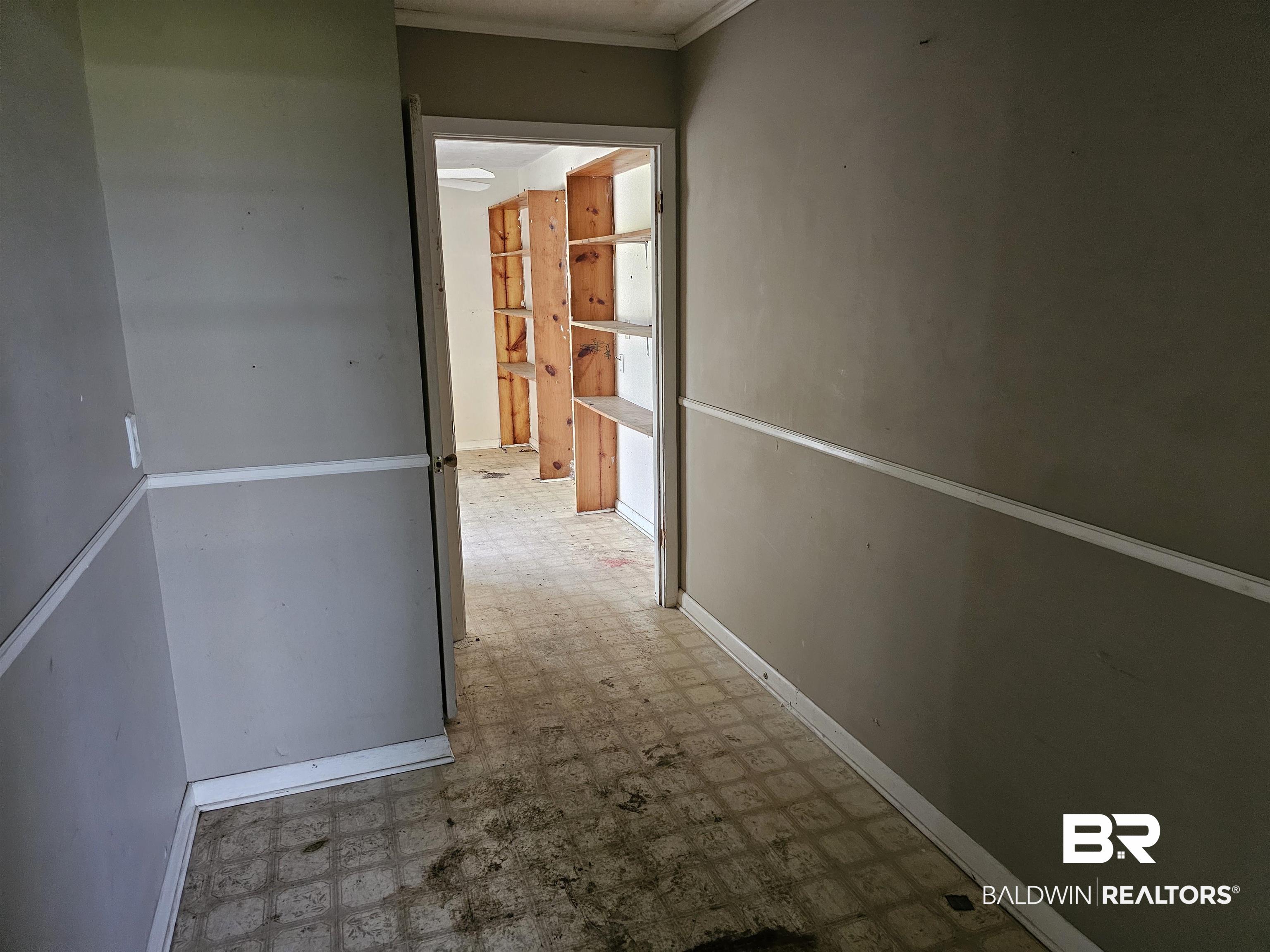 59575 Lottie Road Atmore, AL 36502 - Photo 13 of 23 Hall with tile patterned floors, baseboards, and crown molding