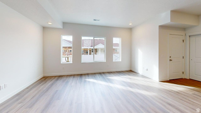 777 Pheasantbrook Drive, Unit 2B Centerville, UT 84014 - Photo 3 of 42 Spacious interior featuring wood-finish flooring, ample natural light from multiple windows, recessed lighting, and crisp white walls