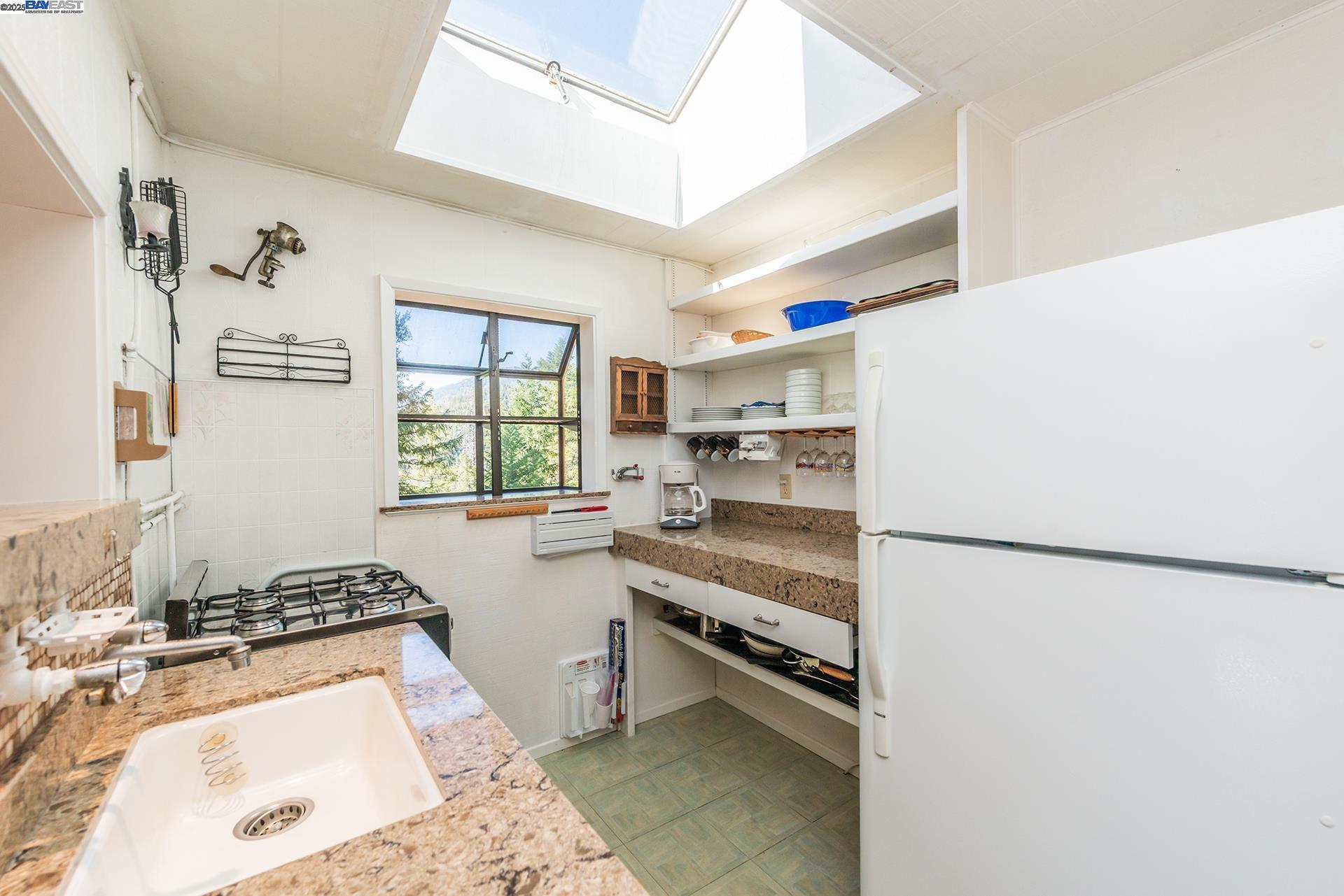 8341 East Side Road Trinity Center, CA 96091 - Photo 19 of 58 a kitchen with a stove a sink and a refrigerator