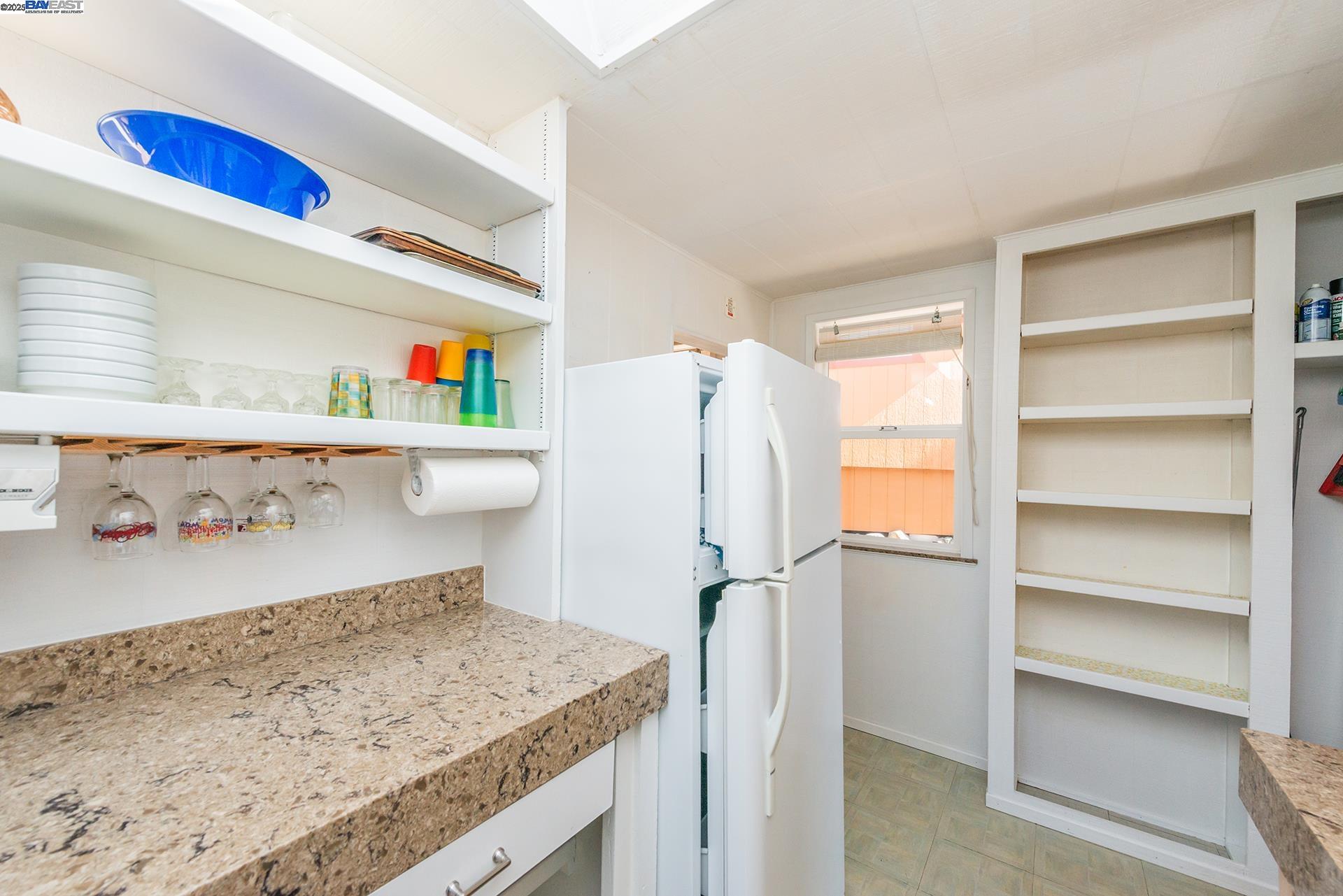 8341 East Side Road Trinity Center, CA 96091 - Photo 23 of 58 a kitchen with a refrigerator and window