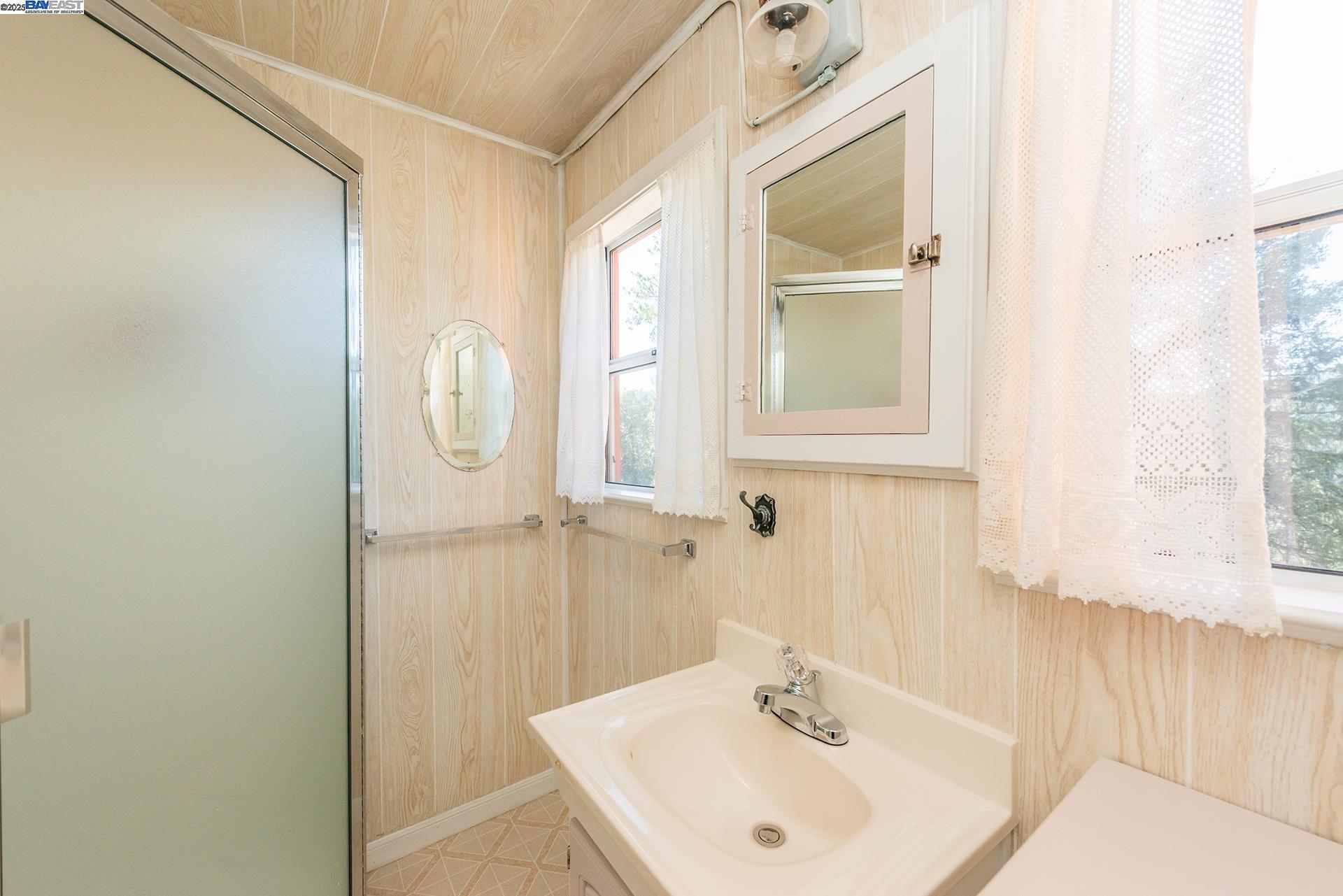 8341 East Side Road Trinity Center, CA 96091 - Photo 24 of 58 a bathroom with a sink a mirror and a window