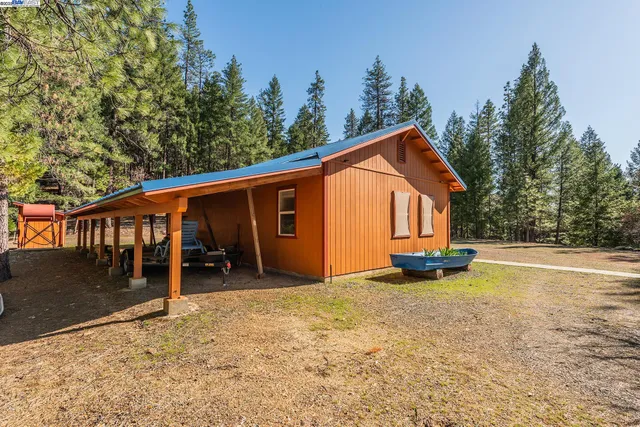 a view of a house with backyard porch and sitting area