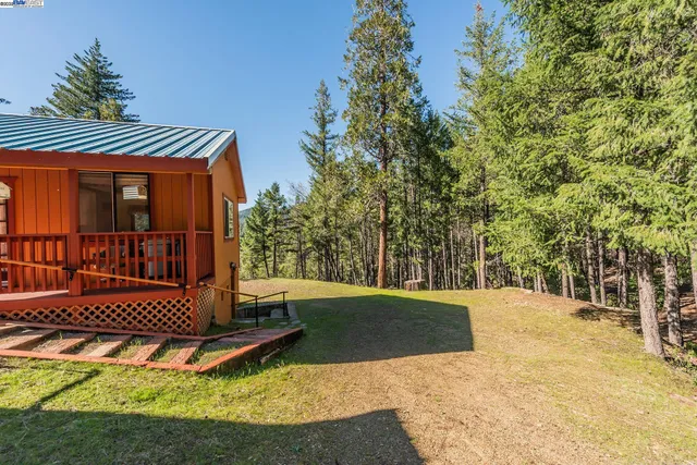 a view of a wooden deck with chairs and a yard