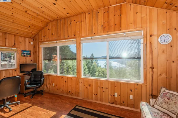 a view of a livingroom with workspace and a window