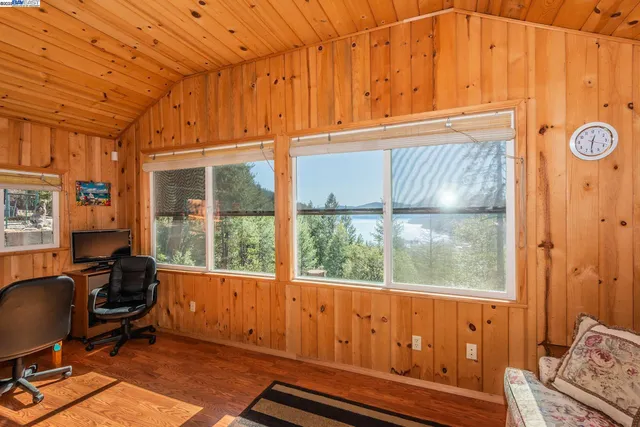 a view of a livingroom with workspace and a window