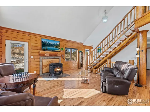 a living room with furniture a ceiling fan and a large window