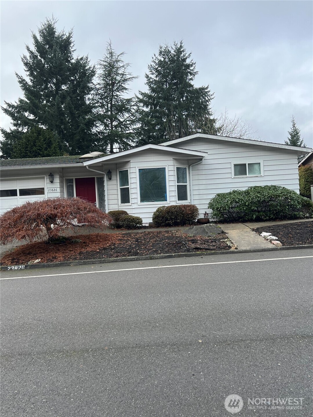 a front view of house with yard and green space