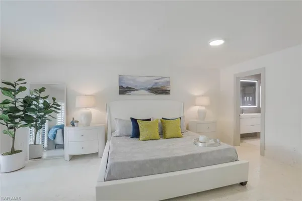 a bedroom with a large bed and a window