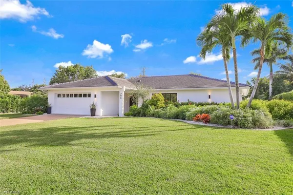 a view of a house with a yard and garage
