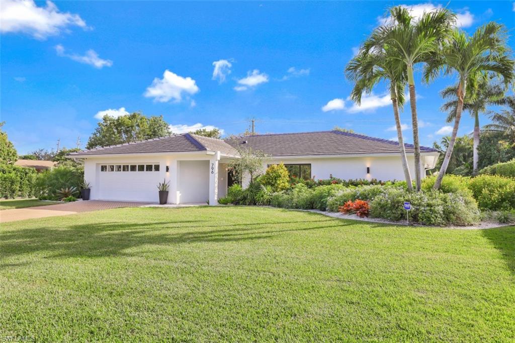 796 Ketch Drive Naples, FL 34103 - Photo 2 of 13 a view of a house with a yard and garage