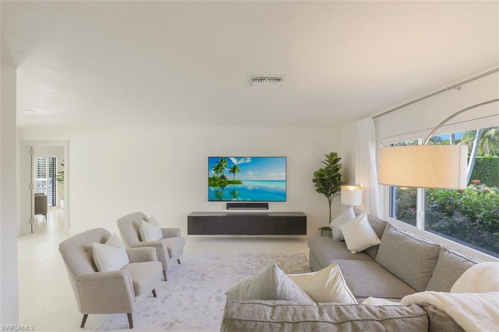 796 Ketch Drive Naples, FL 34103 - Photo 4 of 13 a living room with furniture a rug and a flat screen tv