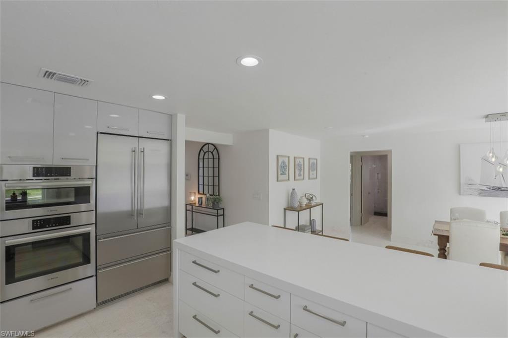 796 Ketch Drive Naples, FL 34103 - Photo 8 of 13 a kitchen with cabinets and stainless steel appliances
