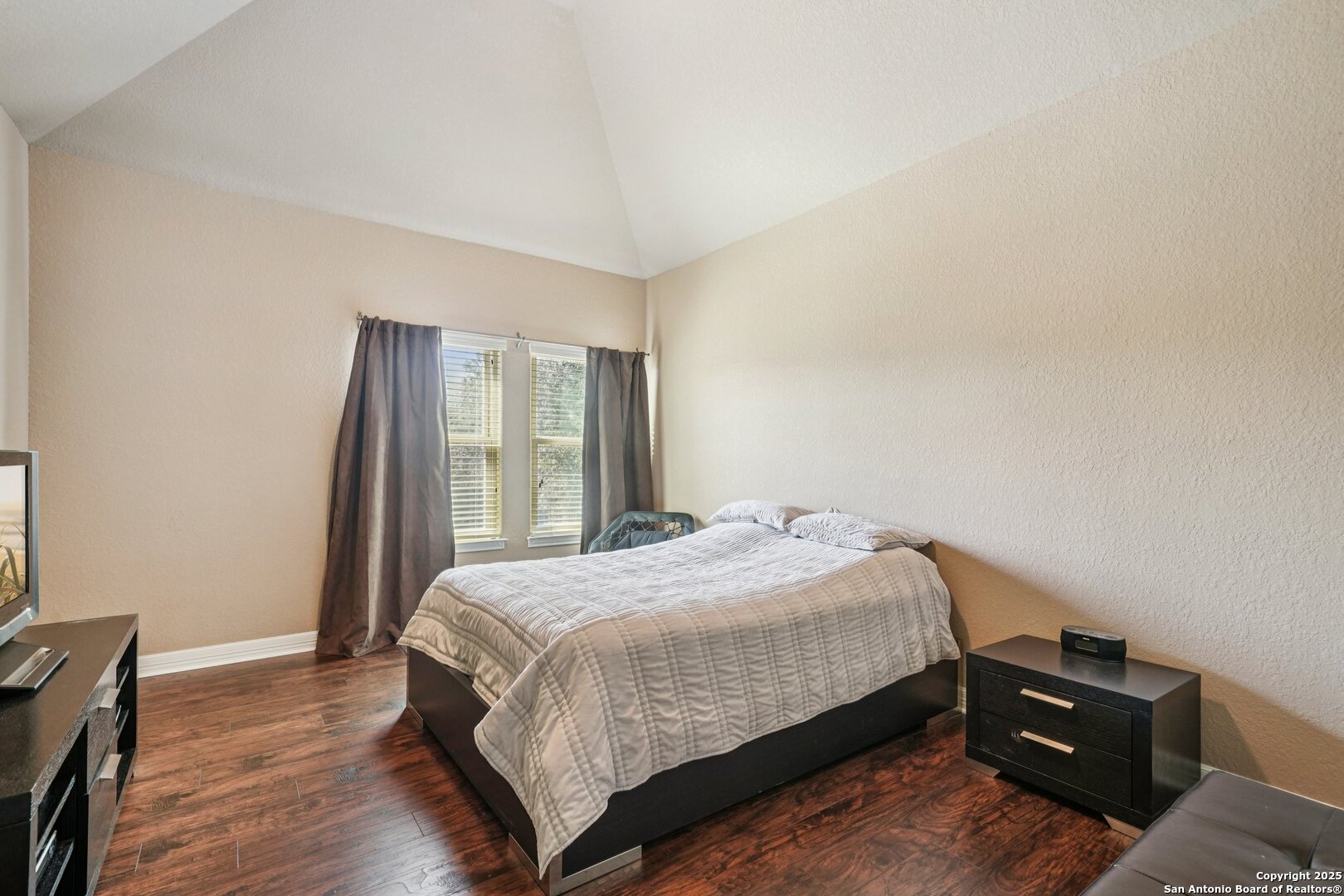 718 Ruidosa Downs Helotes, TX 78023 - Photo 29 of 50 a bedroom with a bed and wooden floor