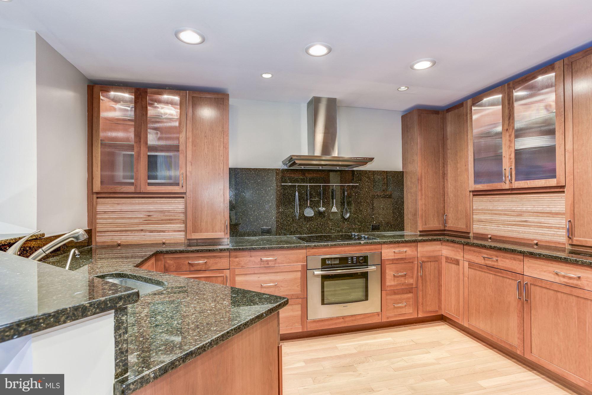 1965 Lakeport Way Reston, VA 20191 - Photo 11 of 28 a kitchen with stainless steel appliances granite countertop a sink and a stove next to a large window