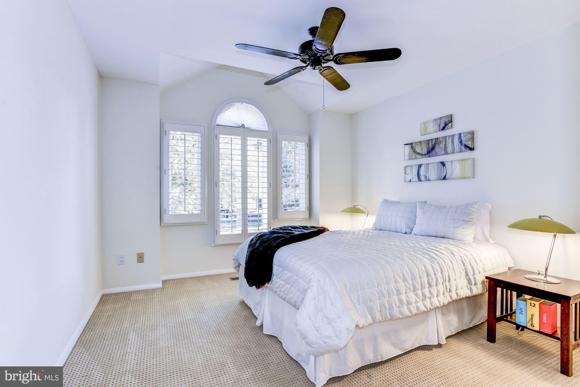 1965 Lakeport Way Reston, VA 20191 - Photo 17 of 28 a bedroom with a bed and a chandelier