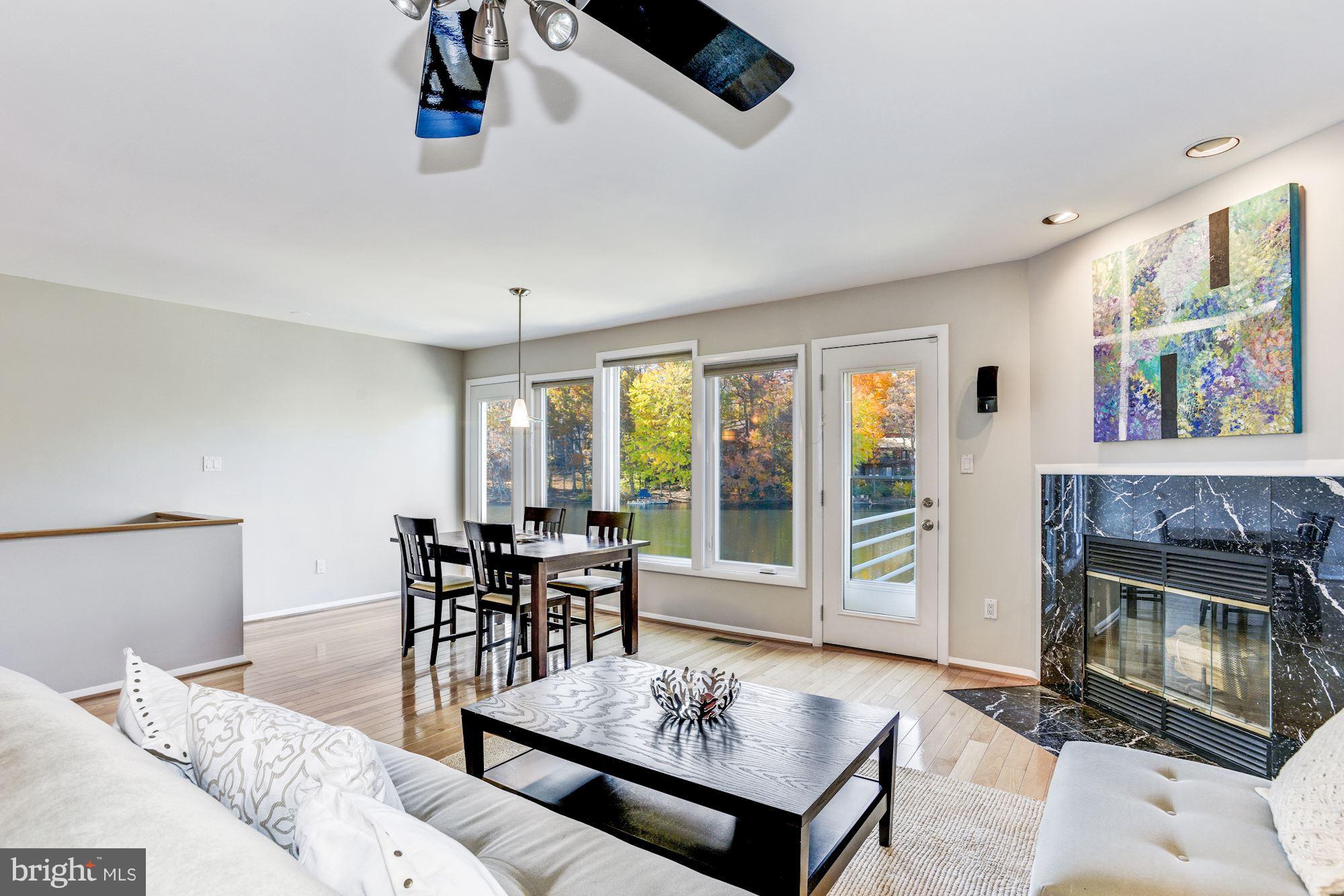 1965 Lakeport Way Reston, VA 20191 - Photo 7 of 28 a living room with furniture a fireplace and a large window